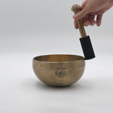 playing crown chakra singing bowl with suede mallet