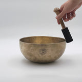 heart chakra singing bowl playing with suede mallet