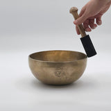 throat chakra singing bowl playing with suede mallet