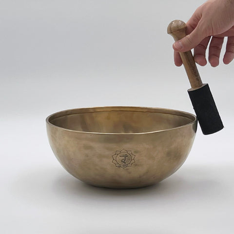 solar plexus chakra singing bowl playing with suede mallet