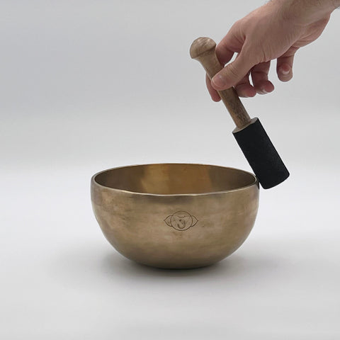 third eye chakra tibetan singing bowl playing with mallet